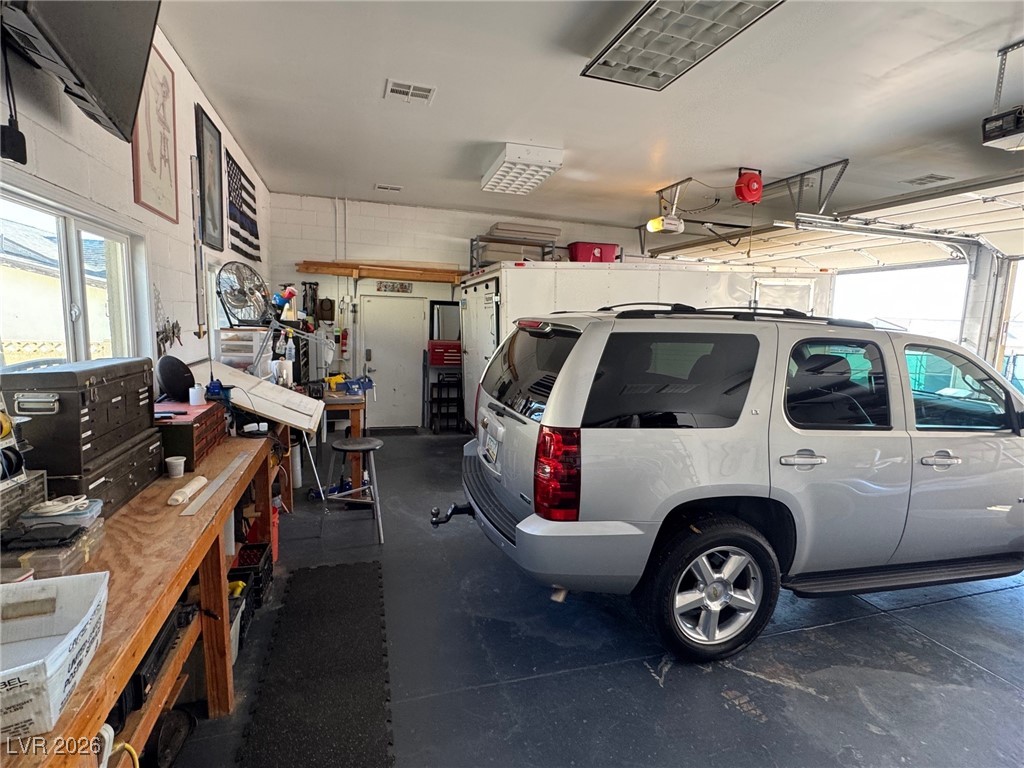 504 I Avenue Boulder City, NV 89005 - Photo 60 of 60 Garage with a workshop area and a garage door opener