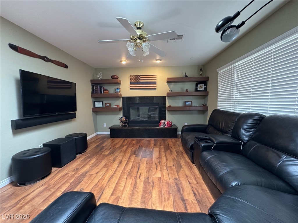 504 I Avenue Boulder City, NV 89005 - Photo 10 of 60 Living room featuring a tile fireplace, light wood-type flooring, and a ceiling fan