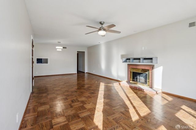 a view of an empty room with a fireplace