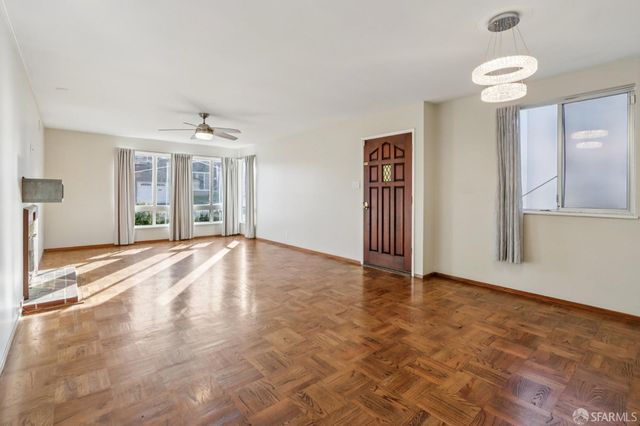 an empty room with windows and entrance