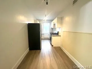 a view of a kitchen with wooden floor