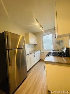 69 Harney Road, Unit 6B Scarsdale, NY 10583 - Photo 3 of 11 a kitchen with a sink a refrigerator and a stove