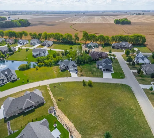 an aerial view of a residential houses with outdoor space