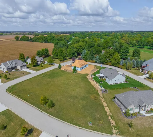 an aerial view of a house with a swimming pool yard and outdoor seating