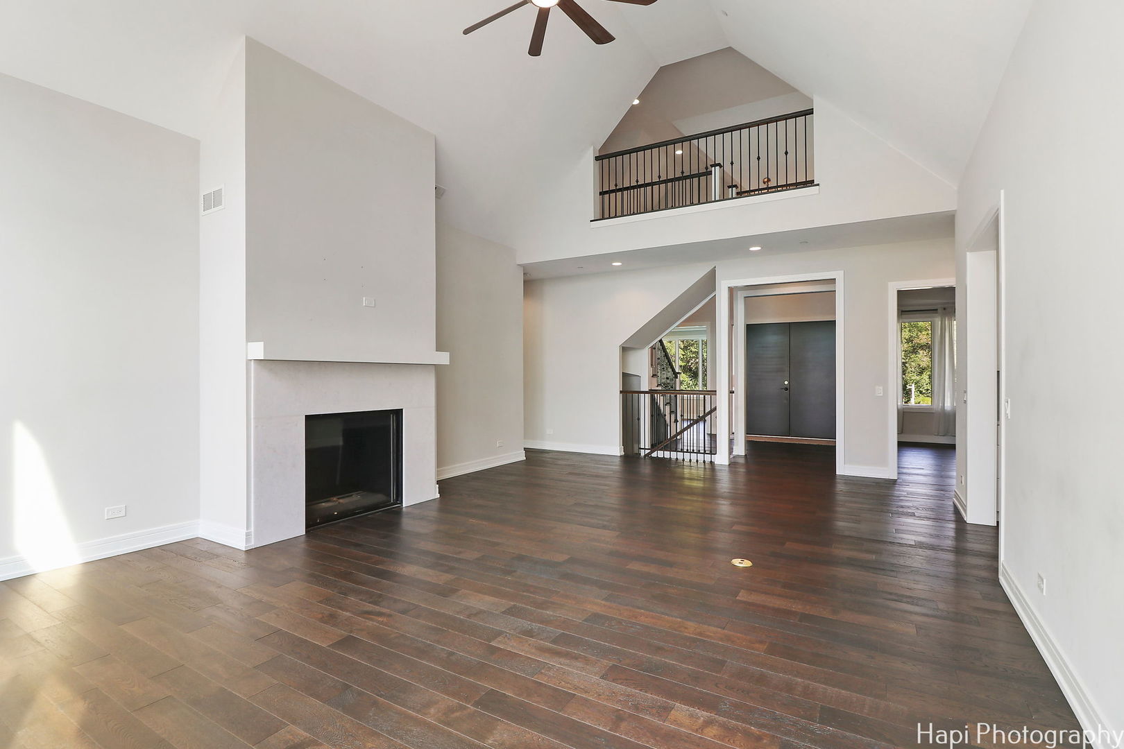 4285 Hilltop Road Long Grove, IL 60047 - Photo 7 of 59 an empty room with wooden floor fireplace and windows