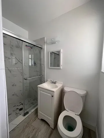 a bathroom with a toilet sink and shower