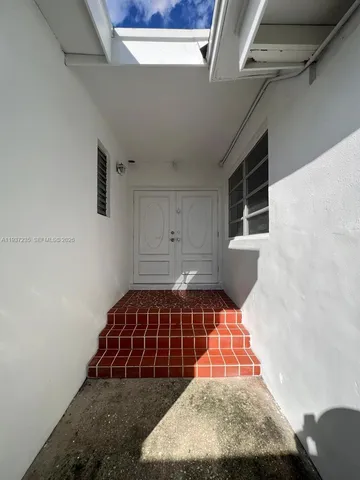 a room with a rug and a window
