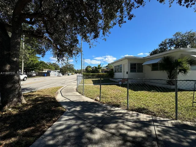 a view of a street with houses on the side