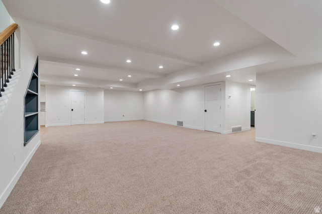 1820 West Farmhouse Flats Road Peoa, UT 84061 - Photo 38 of 79 Spacious lower level featuring plush carpet flooring, recessed lighting, and a built-in shelving unit under the staircase