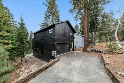 a view of a house with a yard covered in snow