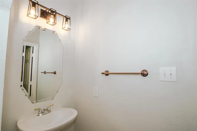 a bathroom with a sink and mirror