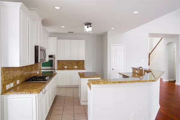 a kitchen with sink refrigerator and stove