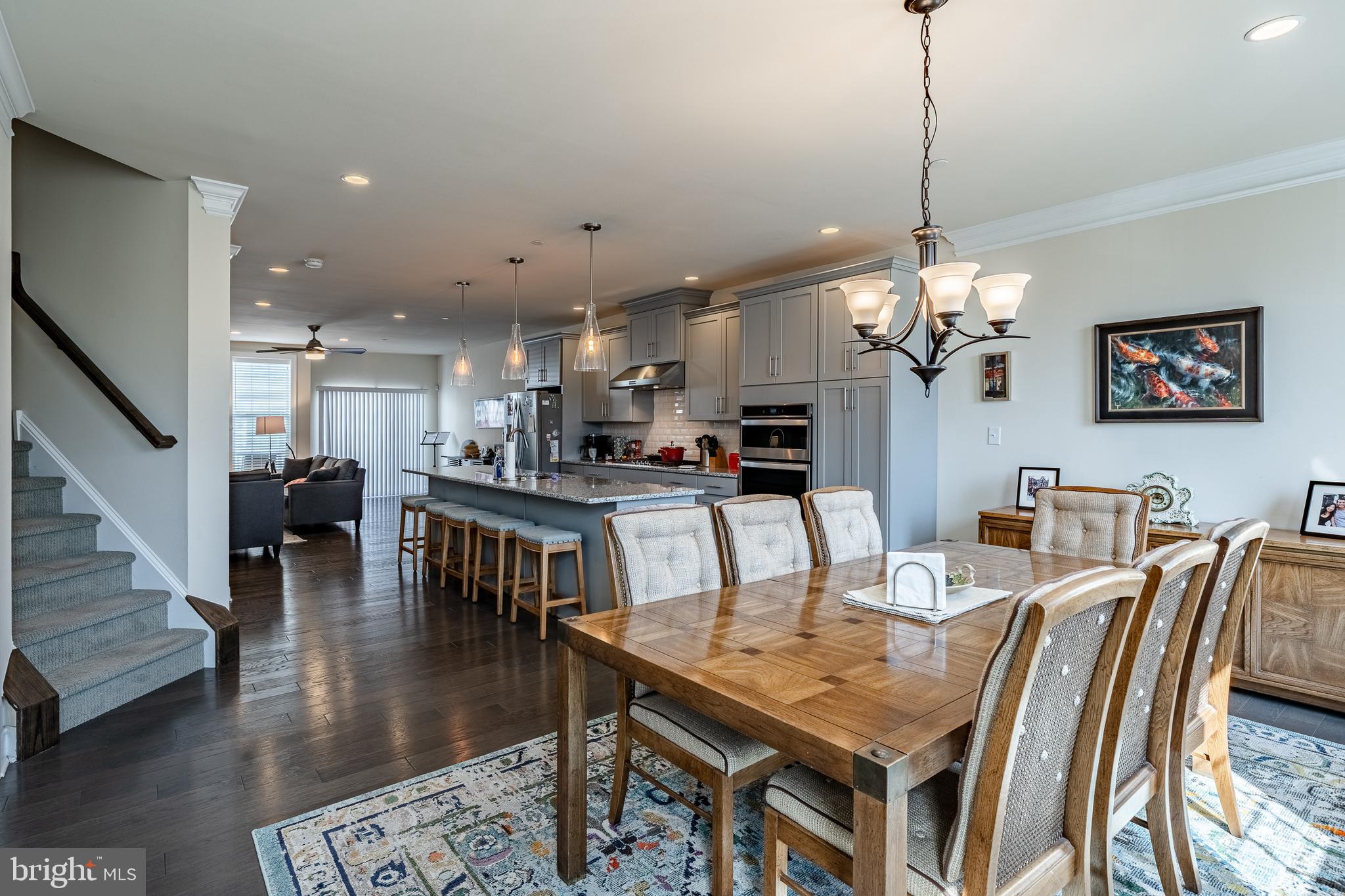 309 Murray Lane Springfield, PA 19064 - Photo 13 of 47 a view of a dining room and livingroom with furniture wooden floor a chandelier