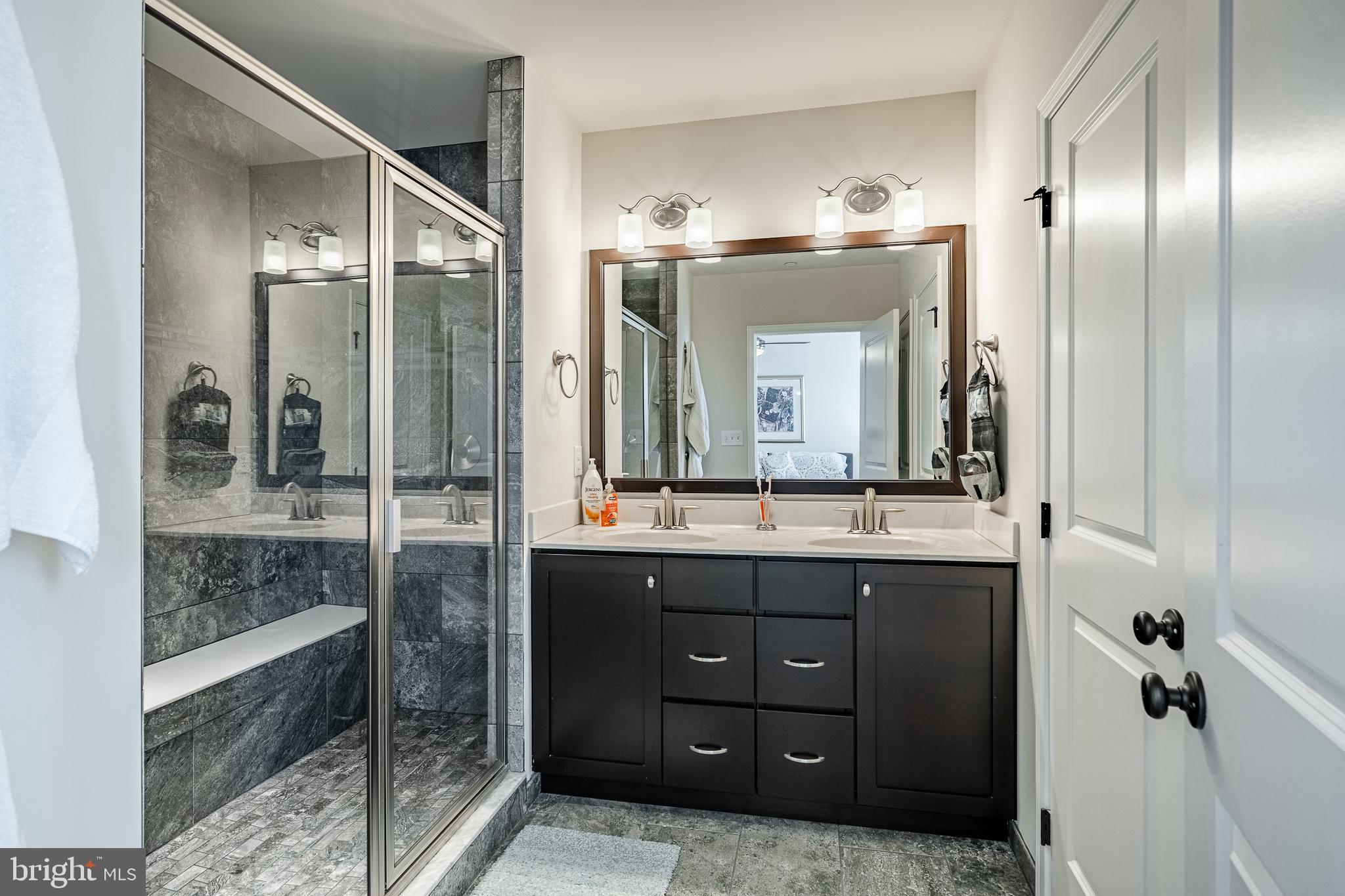 309 Murray Lane Springfield, PA 19064 - Photo 24 of 47 a bathroom with a granite countertop sink mirror and shower