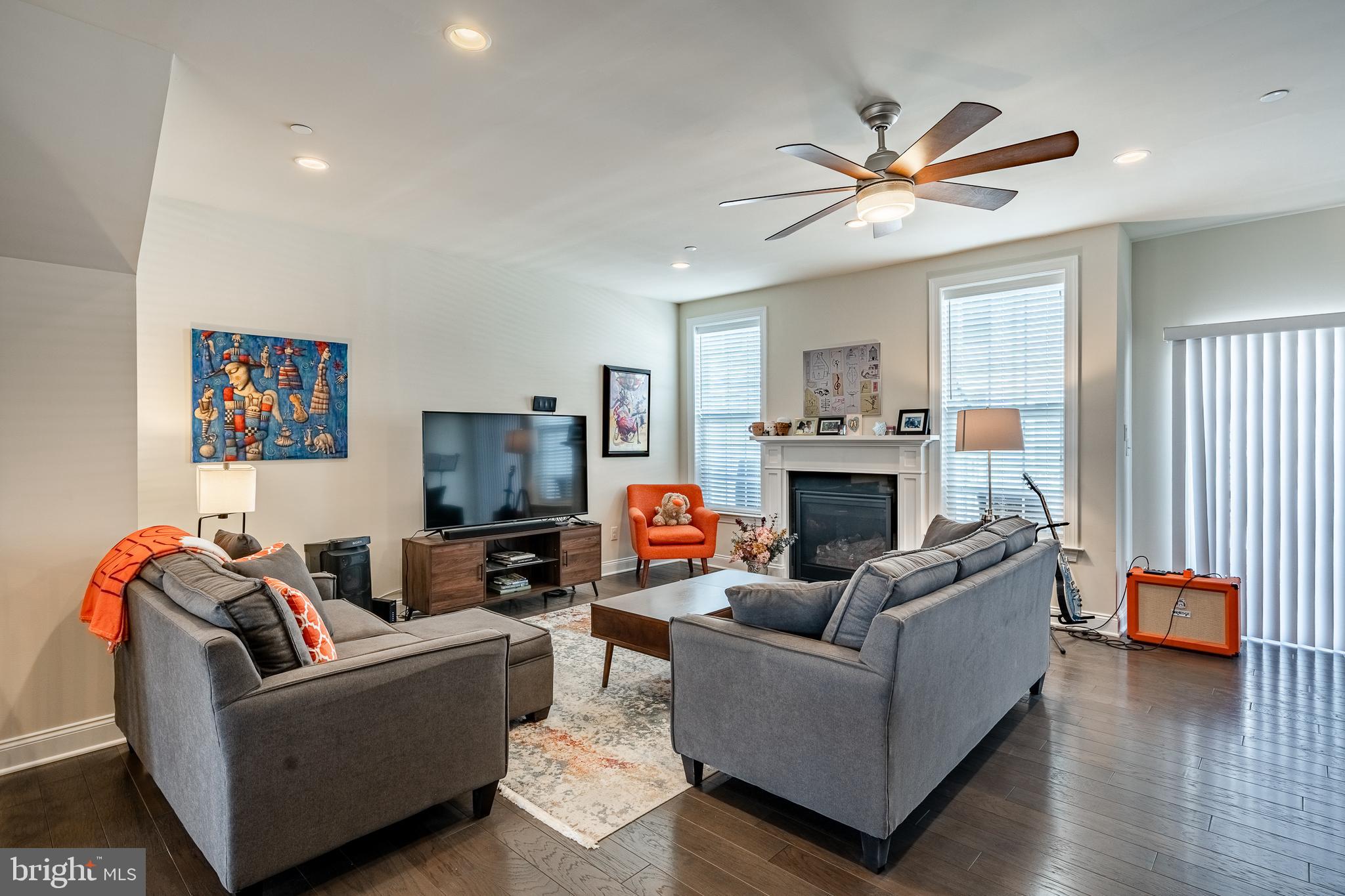309 Murray Lane Springfield, PA 19064 - Photo 4 of 47 a living room with furniture a flat screen tv and a fireplace