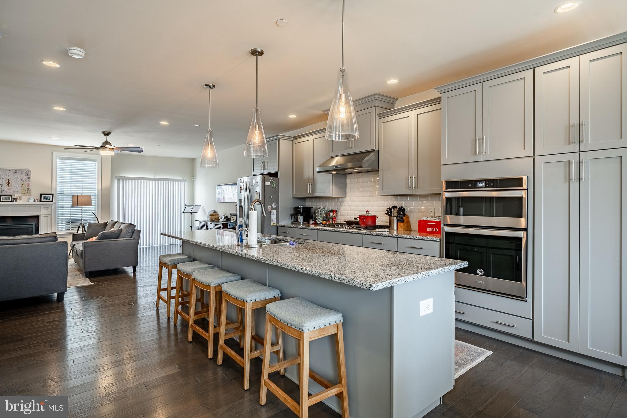 309 Murray Lane Springfield, PA 19064 - Photo 9 of 47 a kitchen with stainless steel appliances granite countertop a table chairs sink refrigerator and cabinets