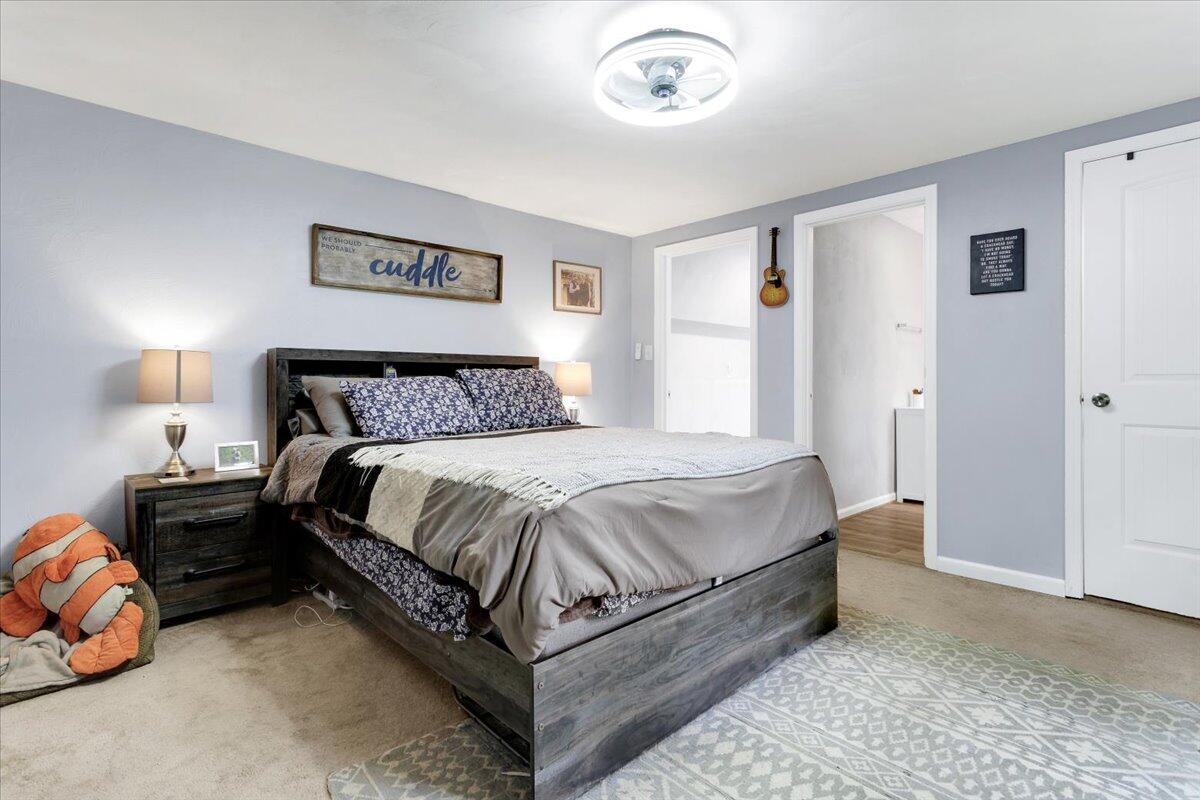 6347 Meacham Road Salem, VA 24153 - Photo 18 of 26 a spacious bedroom with a bed and a lamp