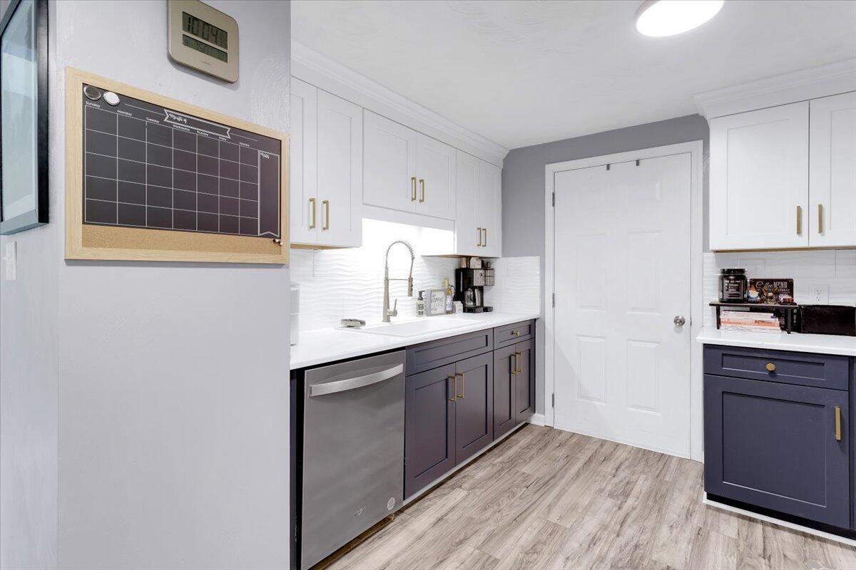 6347 Meacham Road Salem, VA 24153 - Photo 8 of 26 a kitchen with stainless steel appliances a sink cabinets and wooden floor