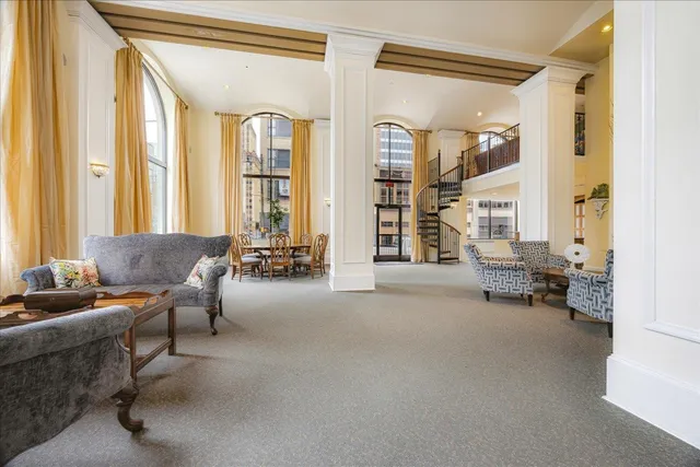 a living room with furniture and large windows