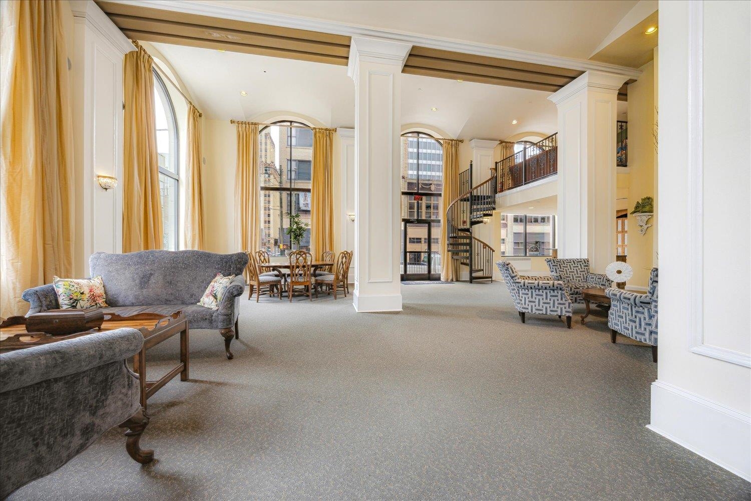 a living room with furniture and large windows