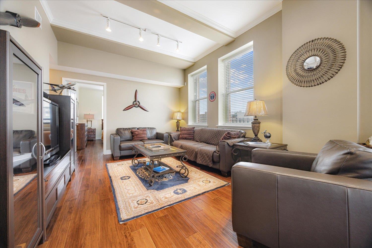 127 Madison Avenue, Unit 602 Memphis, TN 38103 - Photo 11 of 25 a living room with furniture and a flat screen tv