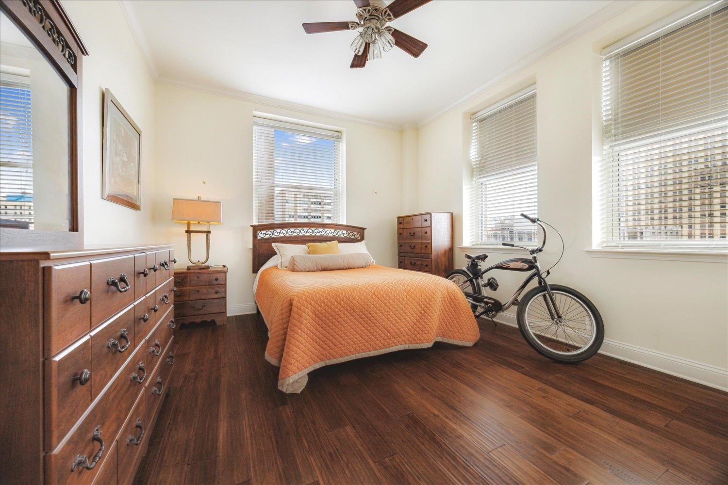 127 Madison Avenue, Unit 602 Memphis, TN 38103 - Photo 12 of 25 a bedroom with a bed and wooden floor