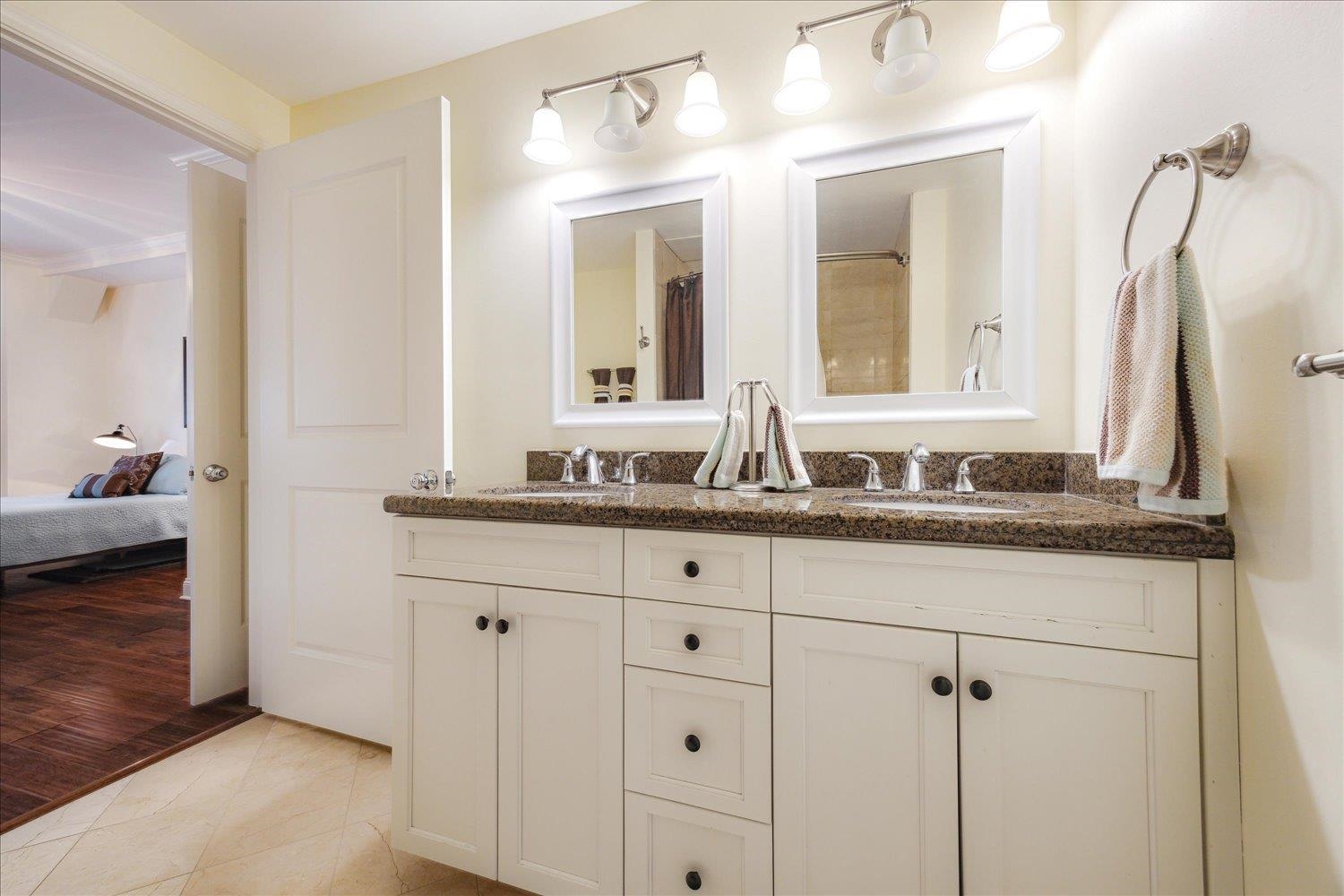 127 Madison Avenue, Unit 602 Memphis, TN 38103 - Photo 24 of 25 Ensuite bathroom featuring double vanity and curtained shower