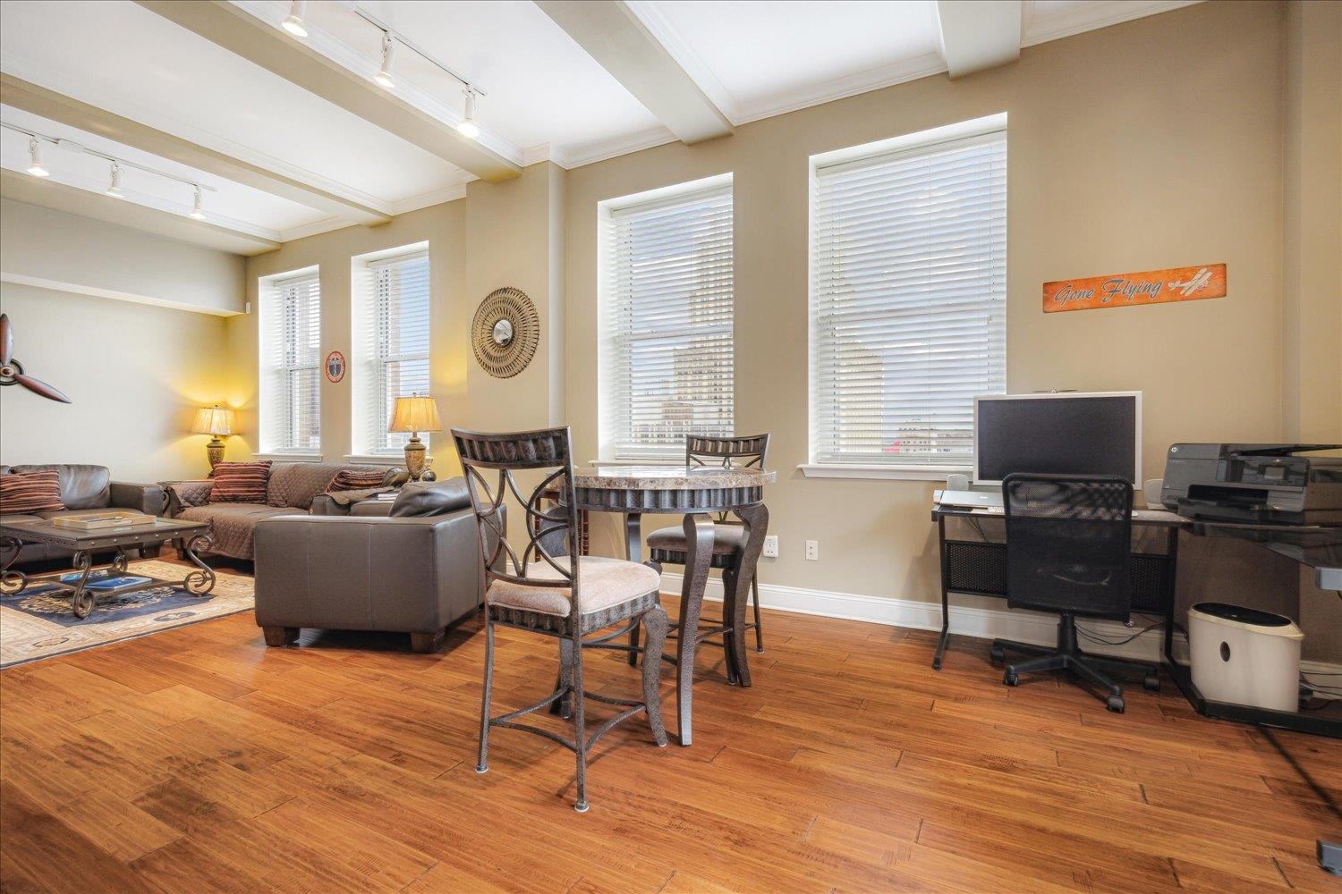 127 Madison Avenue, Unit 602 Memphis, TN 38103 - Photo 10 of 25 a living room with furniture and a flat screen tv