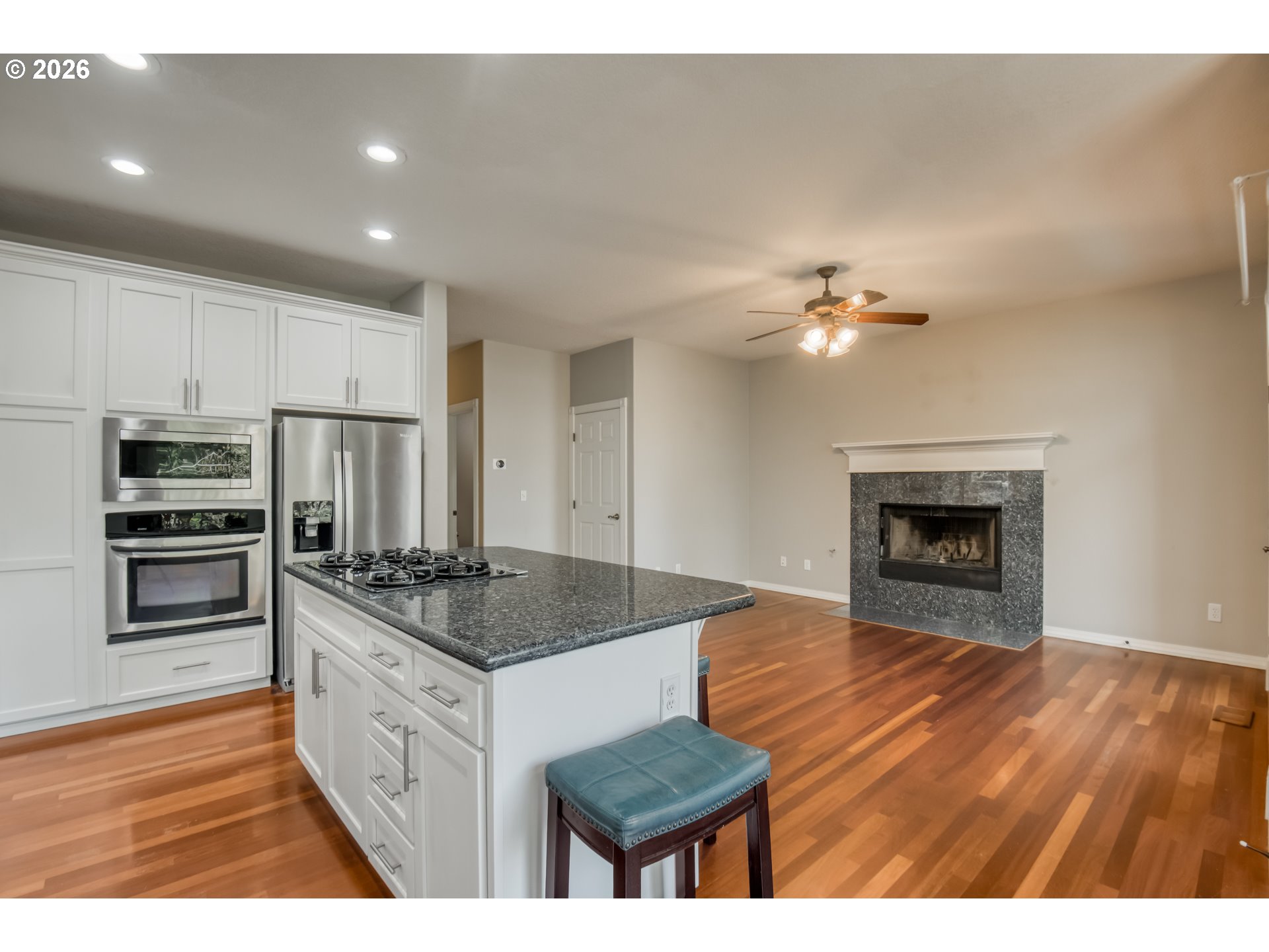9583 Northwest Randall Lane Portland, OR 97229 - Photo 13 of 41 a open kitchen with kitchen island a sink and a stove