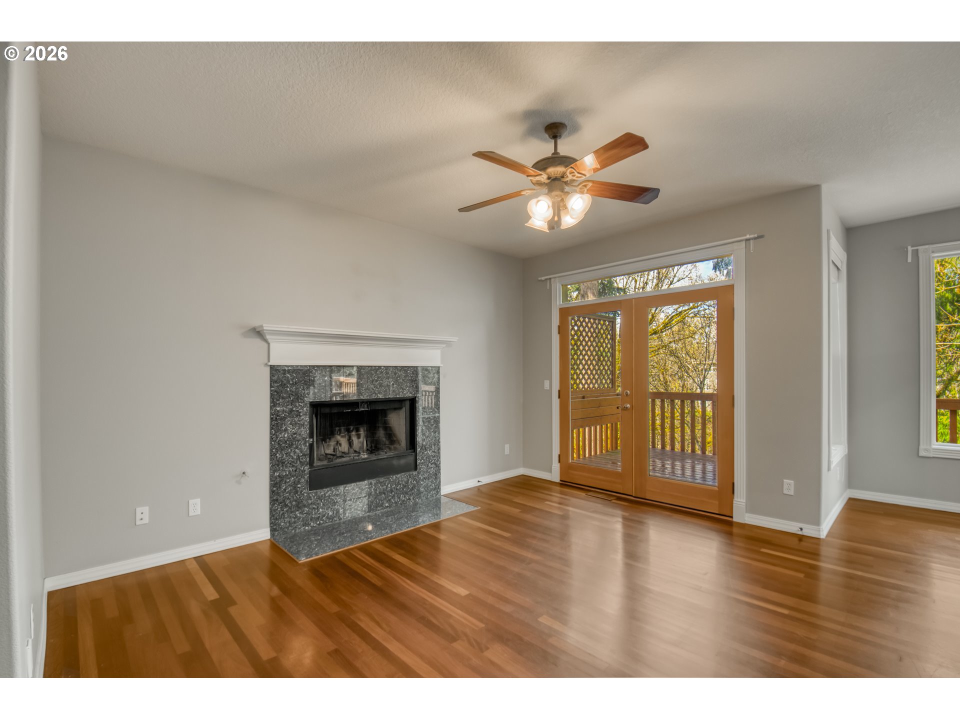 9583 Northwest Randall Lane Portland, OR 97229 - Photo 14 of 41 a view of an empty room with a window and fireplace