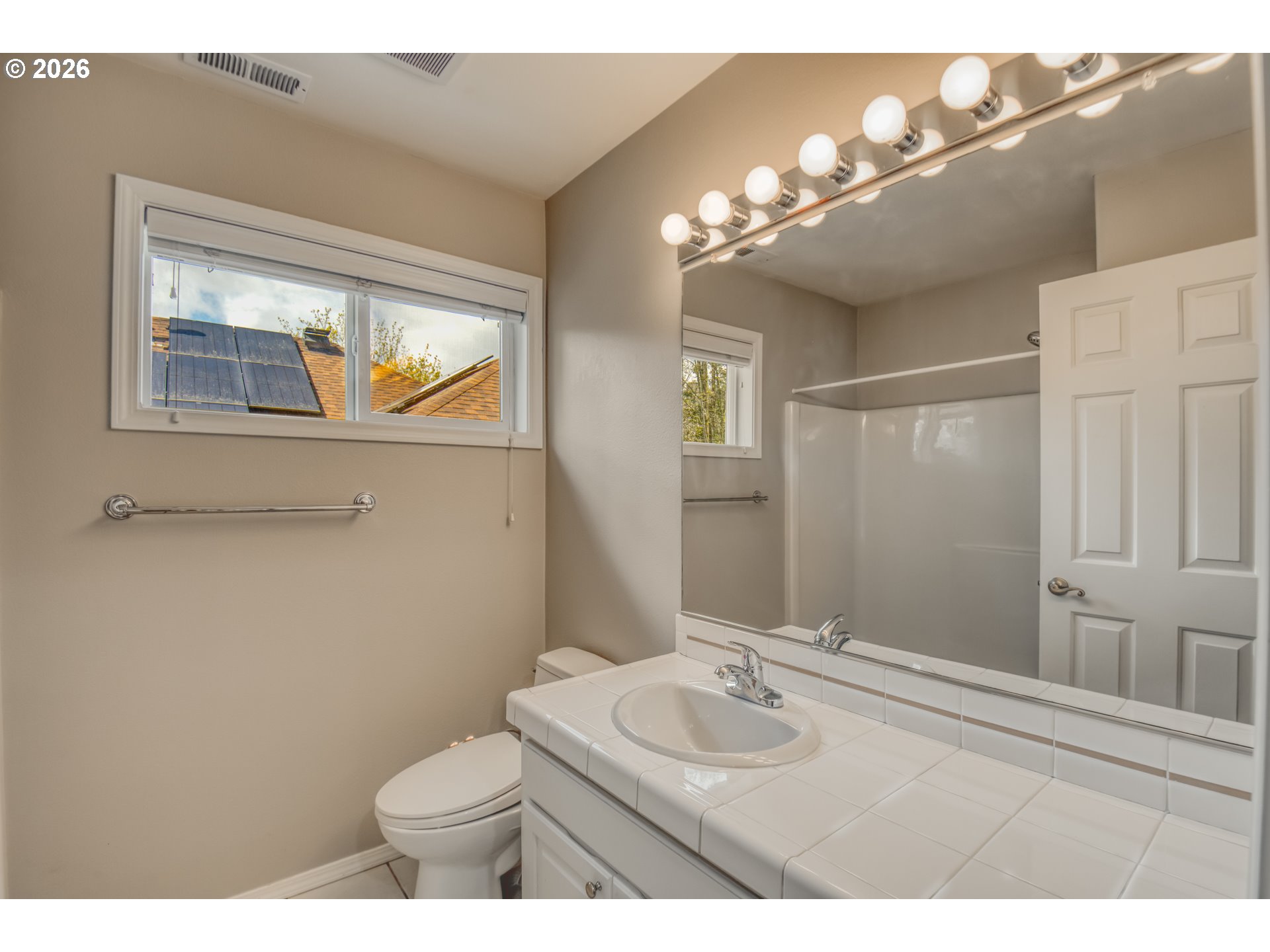 9583 Northwest Randall Lane Portland, OR 97229 - Photo 19 of 41 a bathroom with a toilet a sink and mirror