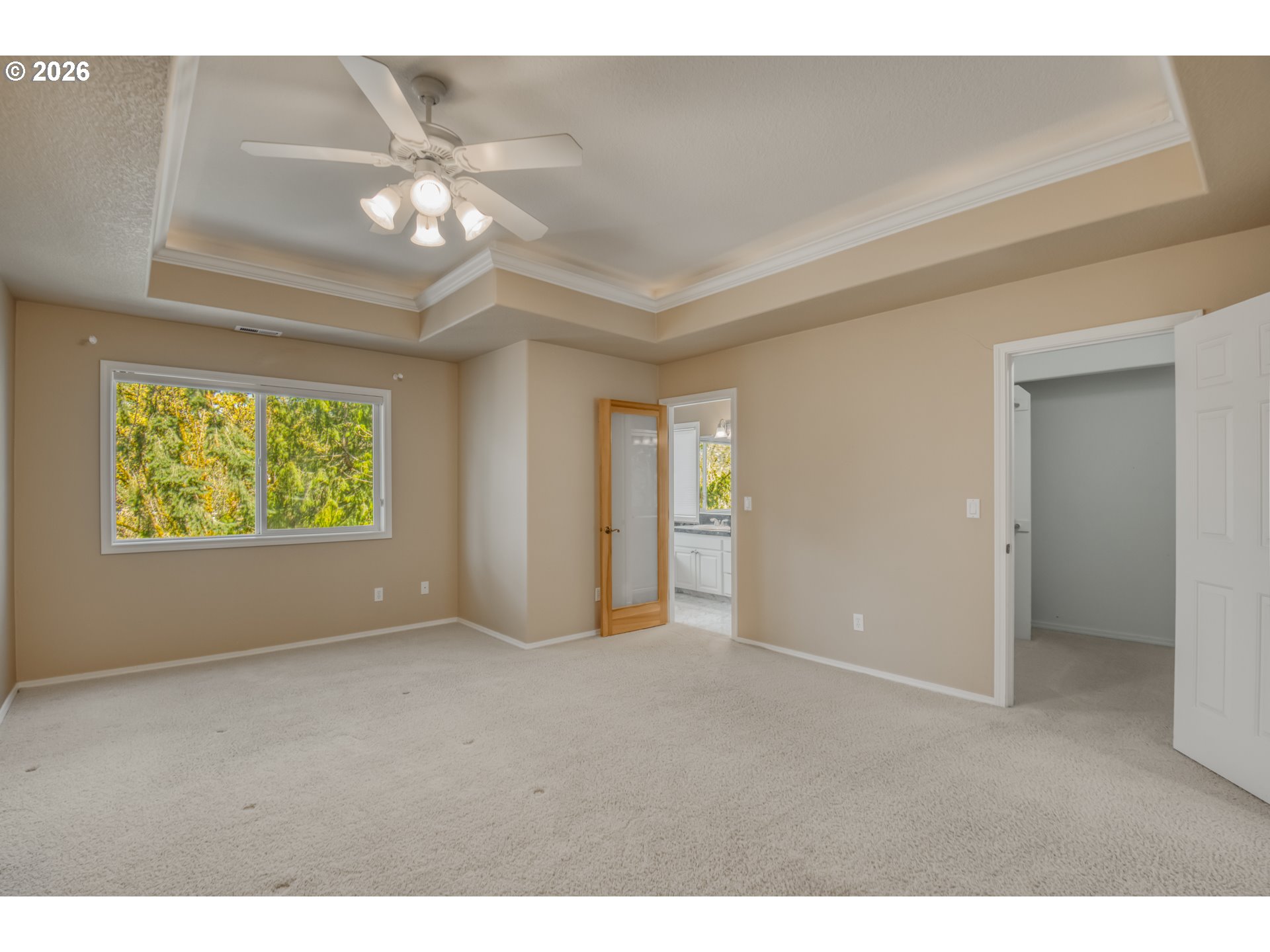 9583 Northwest Randall Lane Portland, OR 97229 - Photo 21 of 41 a view of an empty room with window and chandelier fan
