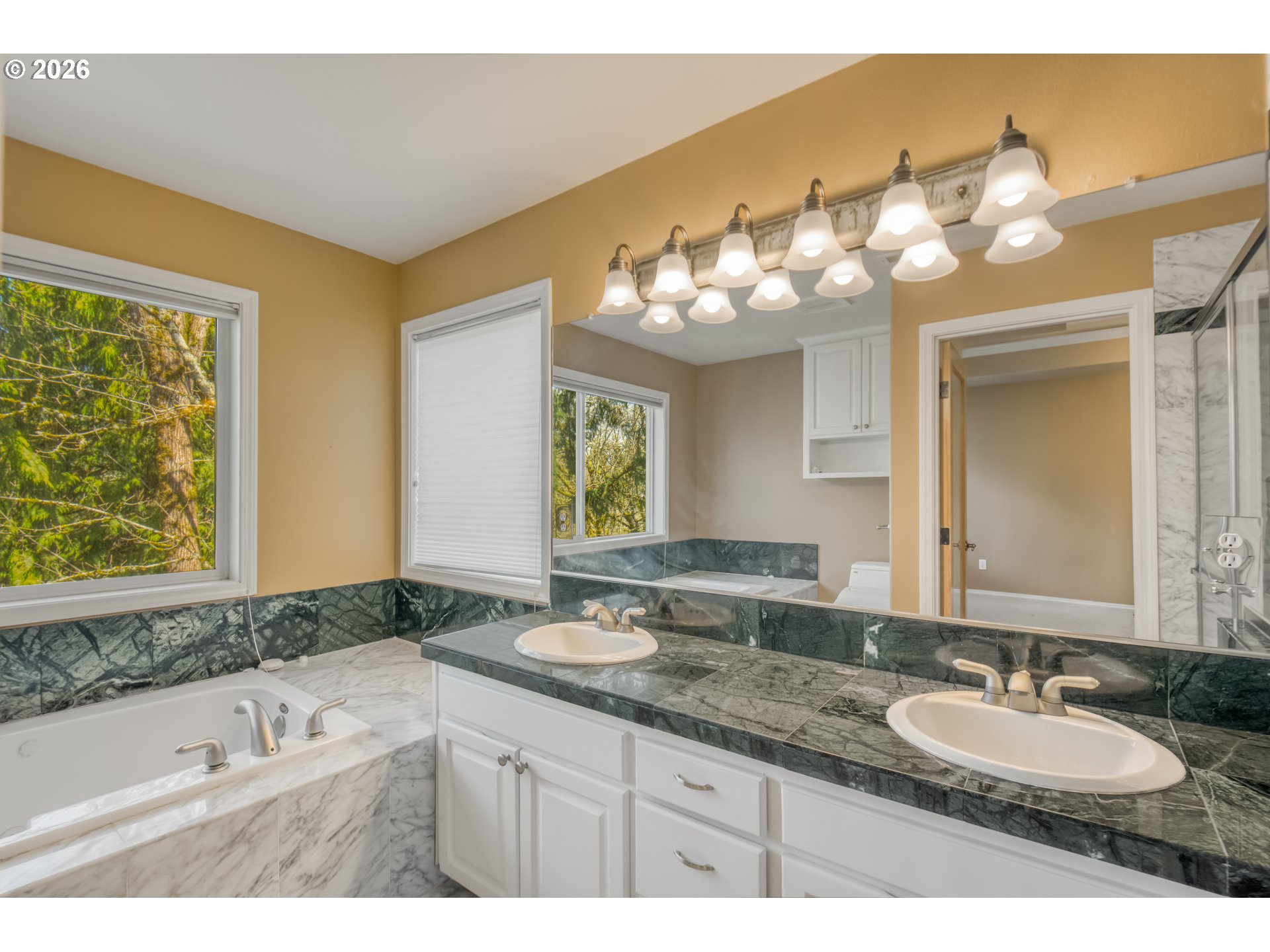 9583 Northwest Randall Lane Portland, OR 97229 - Photo 22 of 41 a bathroom with a double vanity sink and a mirror