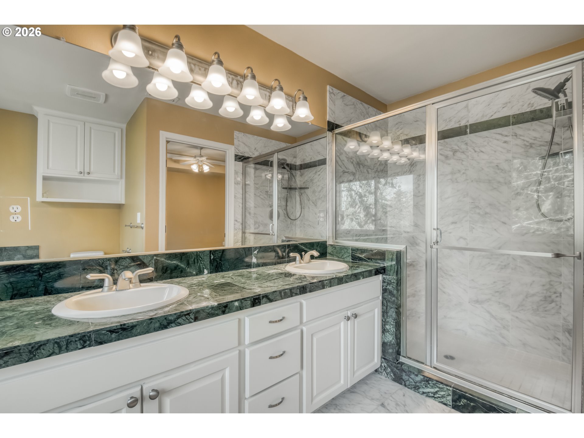 9583 Northwest Randall Lane Portland, OR 97229 - Photo 24 of 41 a bathroom with a granite countertop sink a mirror and a shower