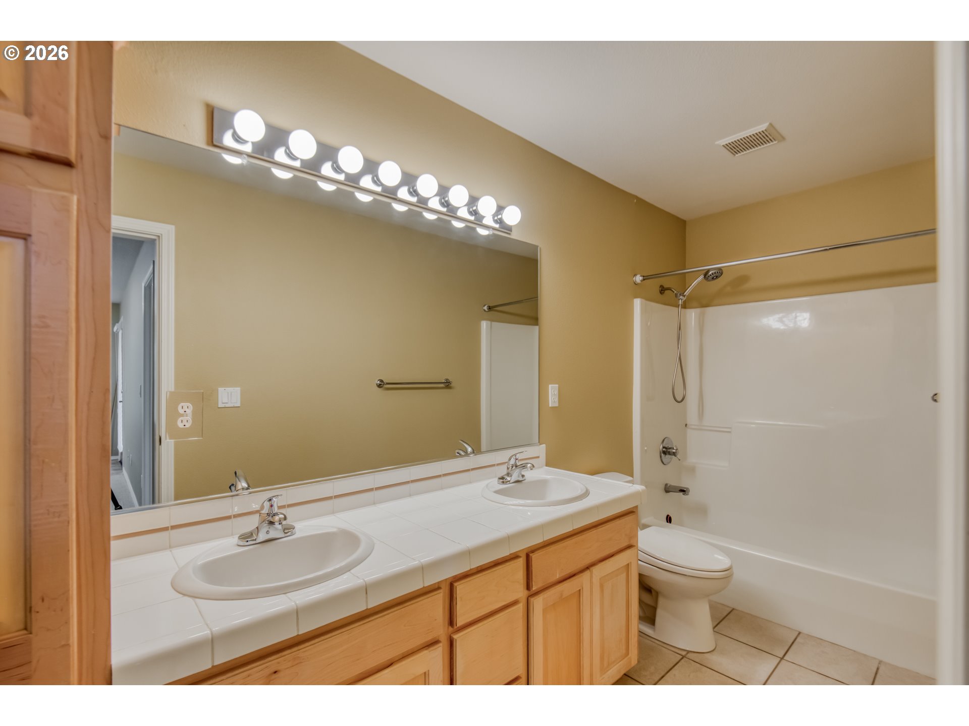 9583 Northwest Randall Lane Portland, OR 97229 - Photo 30 of 41 a bathroom with a granite countertop sink a toilet a mirror a vanity and shower