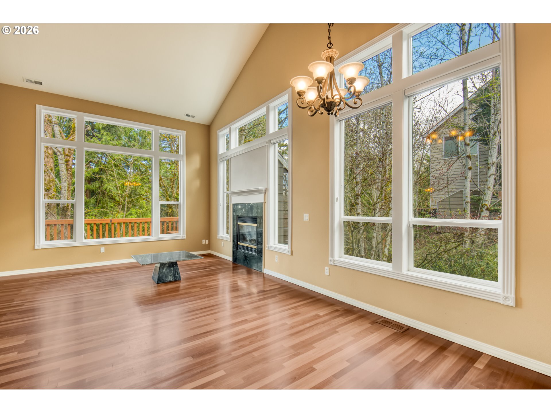 9583 Northwest Randall Lane Portland, OR 97229 - Photo 6 of 41 a view of an empty room with wooden floor and a window