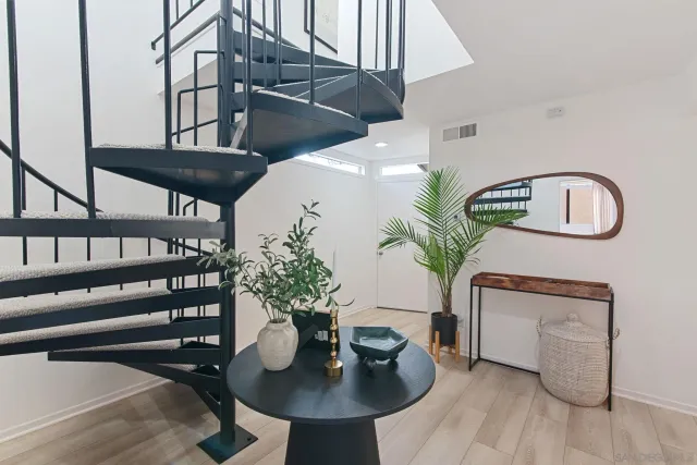 a dining room with furniture and a potted plant