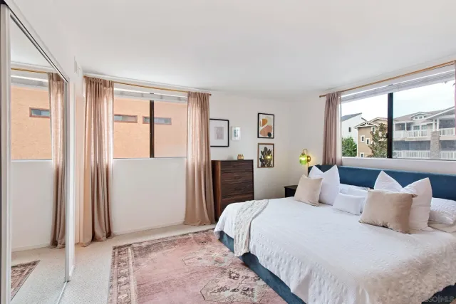 a bedroom with a large bed and a window