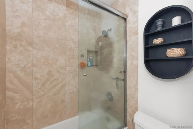 a bathroom with a toilet and a shower