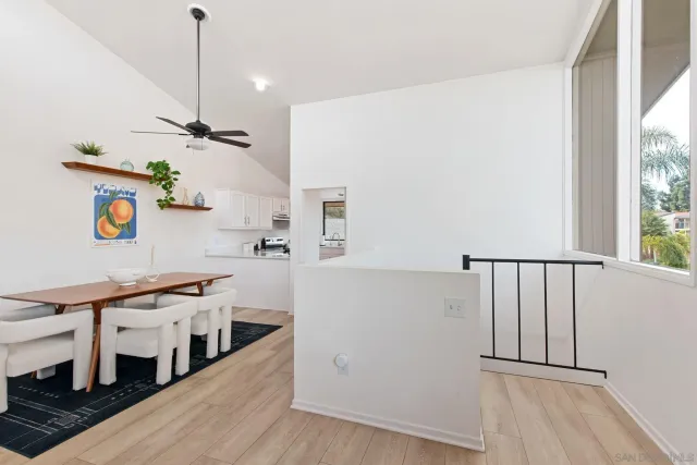 a view of a kitchen with furniture and wooden floor