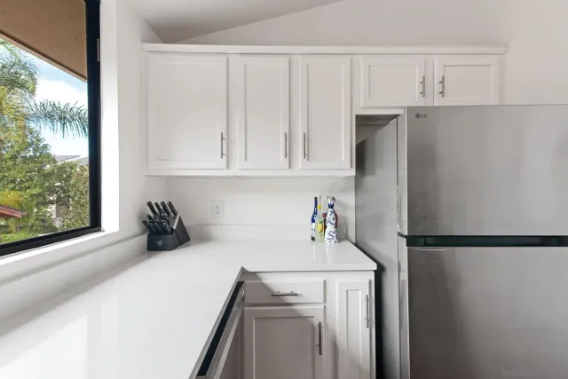 a kitchen with a refrigerator and window