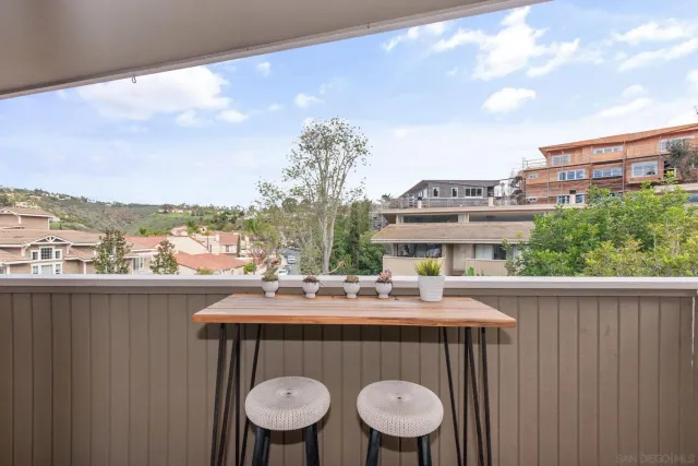 a outdoor dining space with furniture and city view