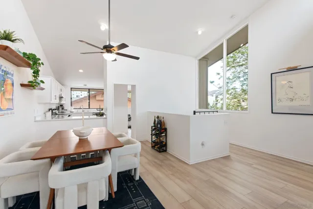 a view of a dining room with furniture and a chandelier