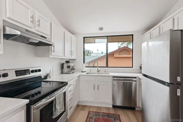 a kitchen with a sink stove and refrigerator