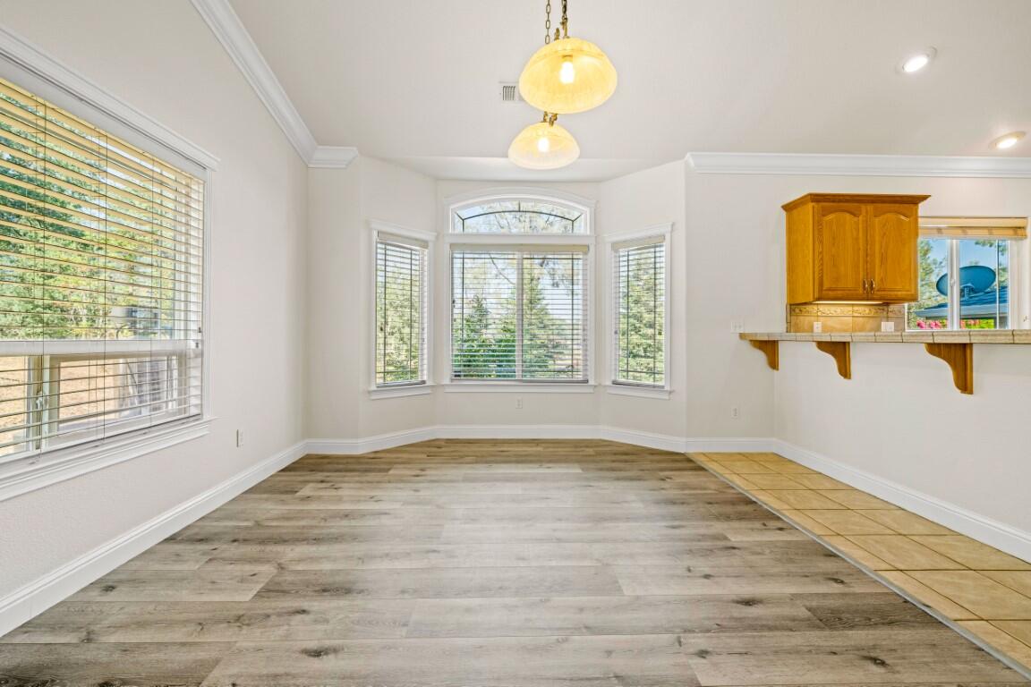 8418 Placer Road Redding, CA 96001 - Photo 15 of 47 a view of an empty room with a window and wooden floor