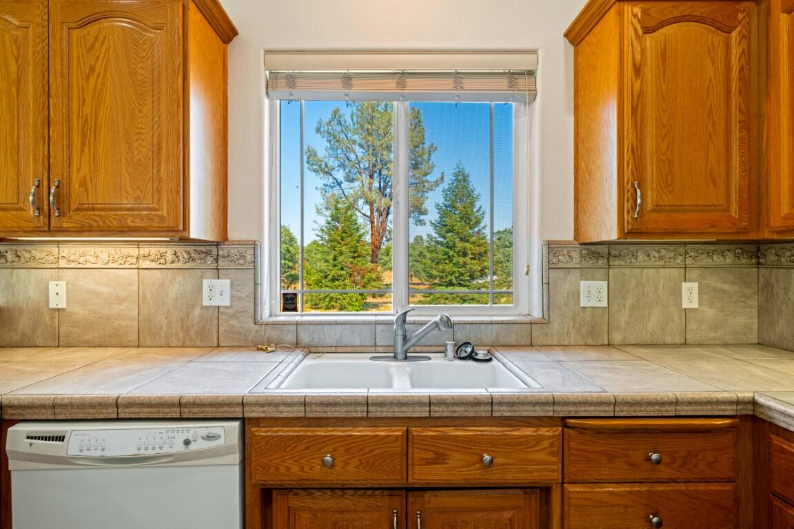 8418 Placer Road Redding, CA 96001 - Photo 24 of 47 a kitchen with a window a sink and a counter top space