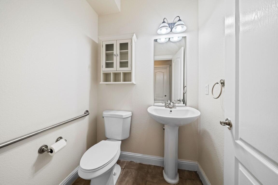 8418 Placer Road Redding, CA 96001 - Photo 25 of 47 a bathroom with a toilet sink and mirror