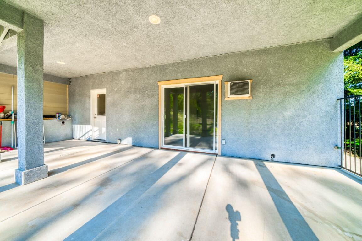 8418 Placer Road Redding, CA 96001 - Photo 30 of 47 a view of a house with a backyard
