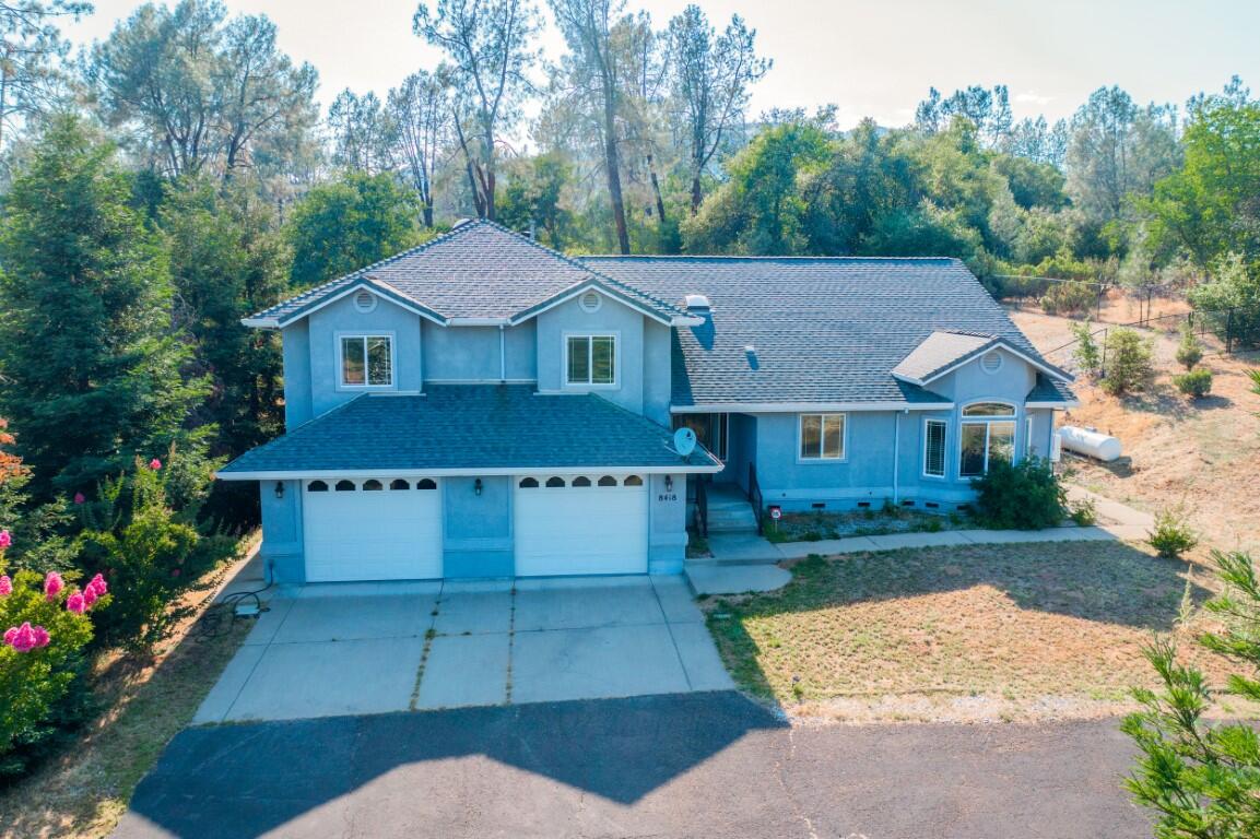 8418 Placer Road Redding, CA 96001 - Photo 34 of 47 a front view of a house with a yard