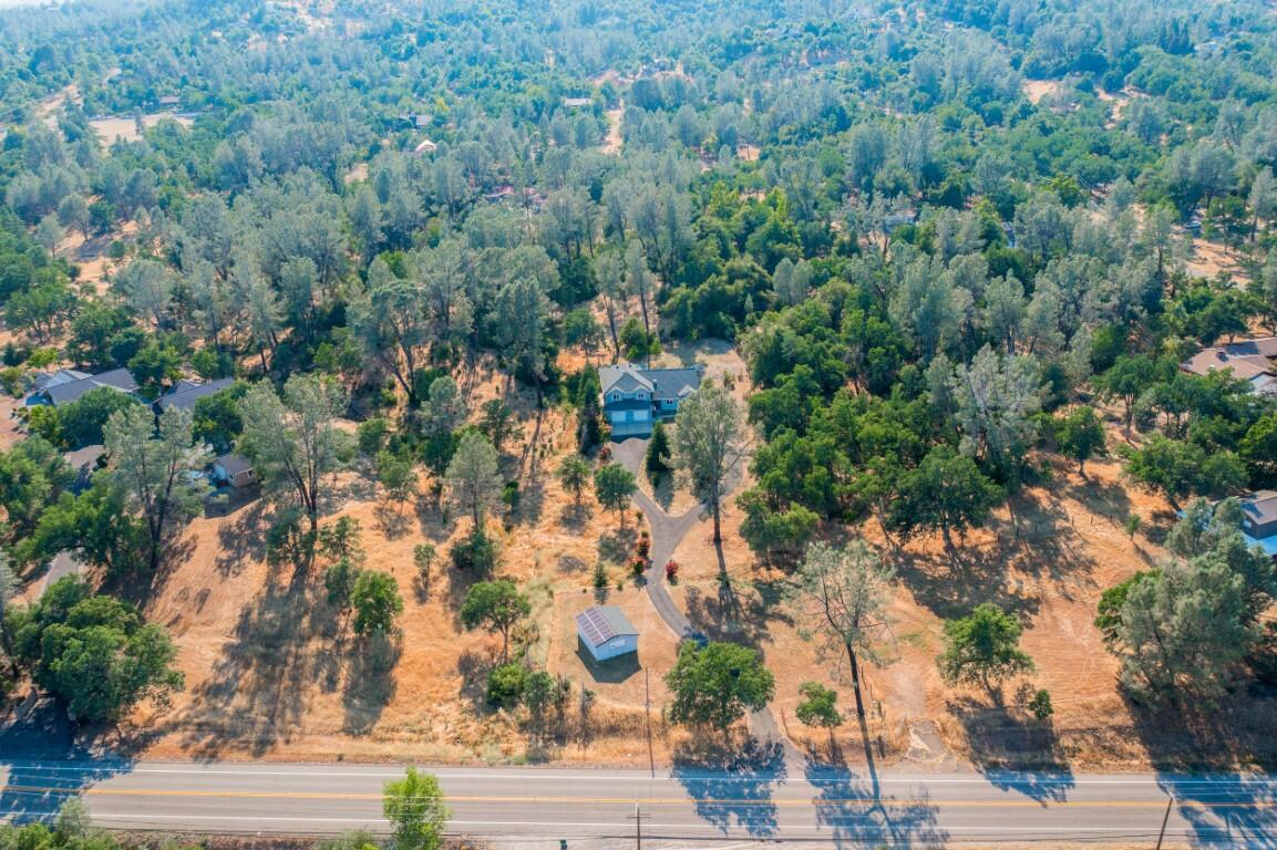 8418 Placer Road Redding, CA 96001 - Photo 39 of 47 an aerial view of residential houses with outdoor space and trees